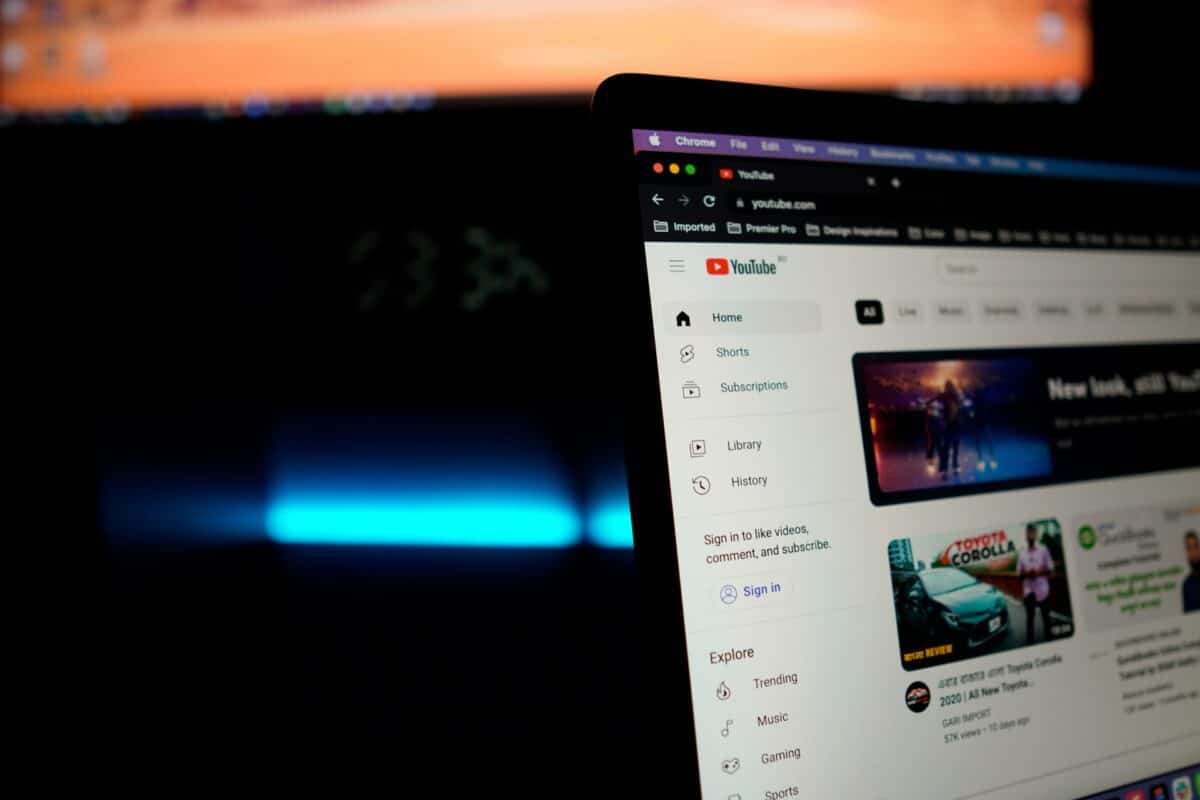 Laptop screen displaying YouTube homepage at night